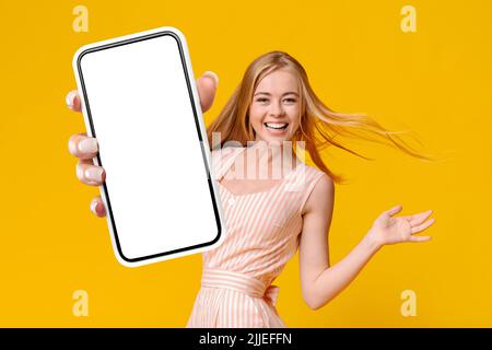 Cheerful Blonde Lady Showing Smartphone With Empty Screen Stock Photo