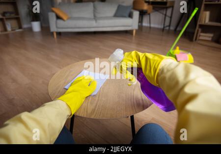 POV Of Woman Cleaning Table With Rag Spraying Detergent Indoors Stock Photo