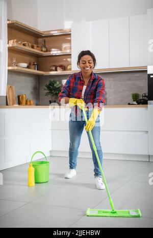 Housewife In Rubber Gloves Washes The Floor At Home. Woman Doing Wet 