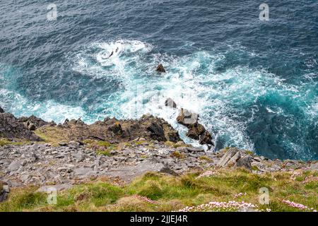 Looking at the sea down the cliffs on the Dingle peninsular, County Kerry, Ireland Stock Photo