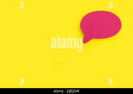 Blank pink speech bubble on a yellow background with copy space Stock Photo