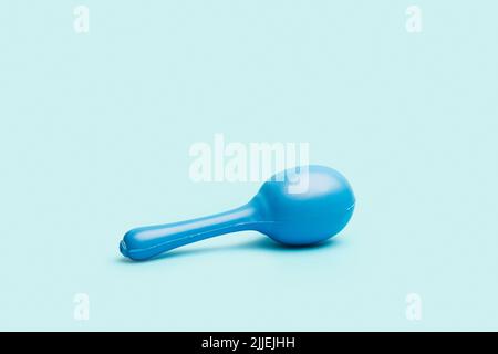 A blue maraca on a light blue background with copy space Stock Photo