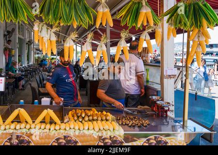 Istanbul, Turkey - June 19 2022: Men selling roasted corn and chestnuts. Stock Photo