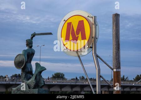 Sign on Centrum Nauki Kopernik of Warsaw Metro line 2, view with Mermaid Statue in Warsaw, capital of Poland Stock Photo