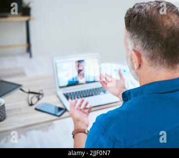 Thanks for joining me today. a mature businessman making a video call using his laptop. Stock Photo