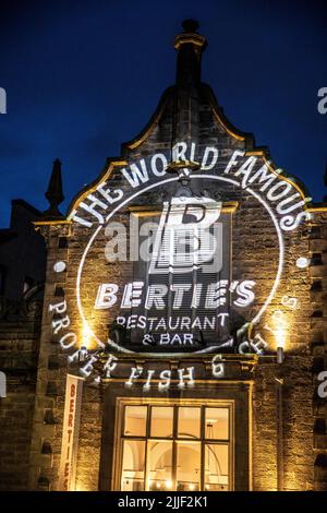 Victoria street Edinburgh at night and world famous Berties fish and chips restaurant illuminated,Scotland,Uk,summer 2022 Stock Photo