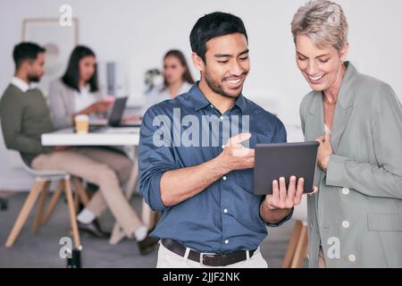 What a cute image. two businesspeople having a conversation while using a digital tablet. Stock Photo