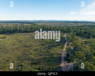 Drone aerial flight over The Willows abandoned sapphire diggings in central Queensland, Australia. Cars and people indistinguishable. Stock Photo