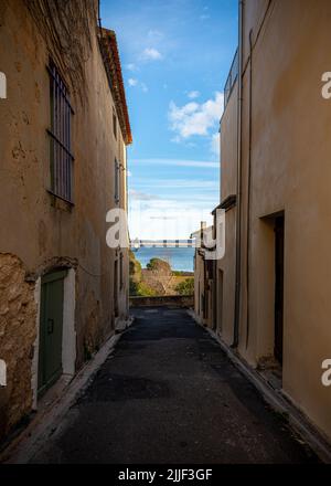 Old street of the village of Gruissan, Southern France, leading to a lake, taken on a sunny winter late afternoon with no people Stock Photo