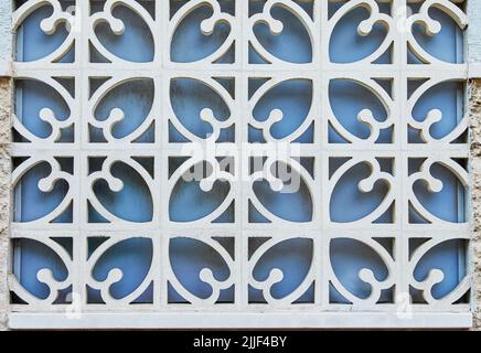 Texture of forged metal lattice against blue window, background Stock Photo