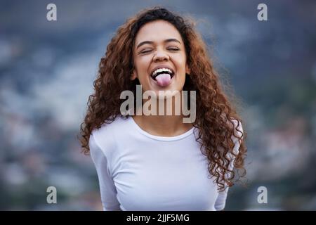 Let go of everything that holds you back. an attractive young woman out for an early morning hike in the mountains. Stock Photo