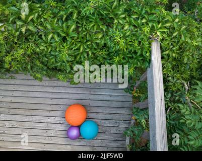 aerial view of a backyard deck with three heavy slam balls filled with sand, exercise and functional fitness concept Stock Photo