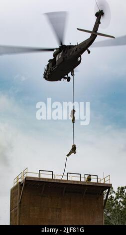 Solders Fast Ropeing Soldiers conduct fast rope insertion training to practice rapid ...