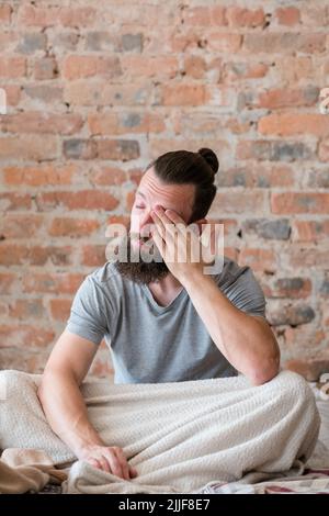 sleep disorder man bed feeling tired sleepy Stock Photo
