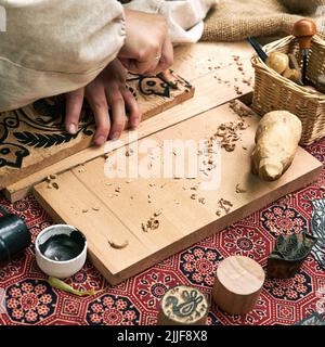 Wooden stamps for medieval ink printing on fabric and vintage clothing. Reconstruction of the events of the Middle Ages in Europe. Stock Photo