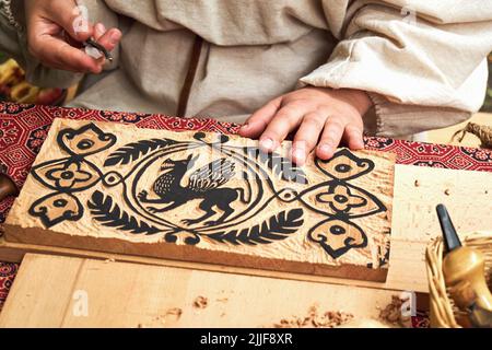 Wooden stamps for medieval ink printing on fabric and vintage clothing. Reconstruction of the events of the Middle Ages in Europe. Stock Photo