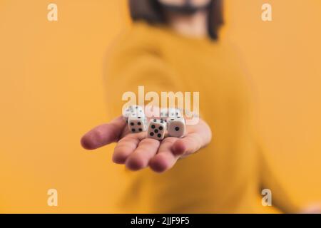 Isolated person holding random boardgame dices drawn by luck on a hand. High quality photo Stock Photo