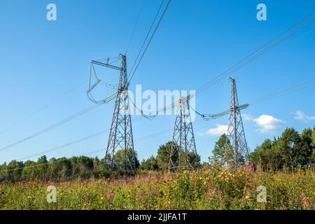 View of fragment of power line as component of large electrical networks and system of power equipment. Electricity transmission, electric current. En Stock Photo