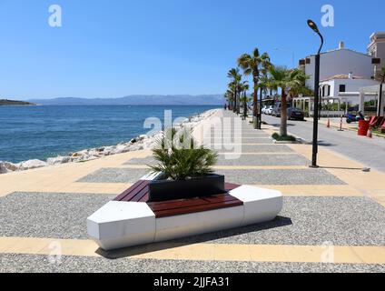 CESME,IZMIR,TURKEY-MAY 20:Street with Palm Trees by the Aegean Sea.May 20,2022 in Cesme,Turkey Stock Photo