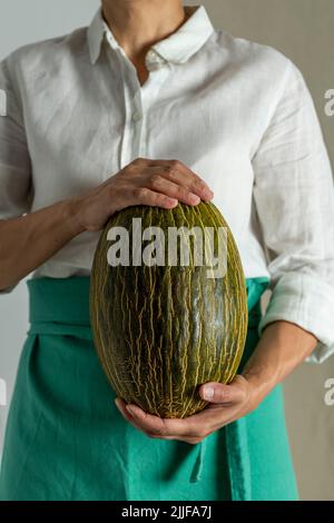 Woman holding a green melon - stock photo Stock Photo