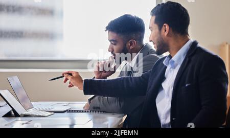 Thats our best bet. two businessmen discussing something on a laptop. Stock Photo
