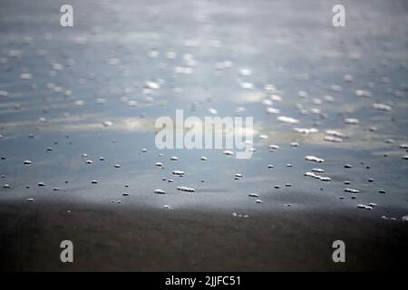 foam on water reflection at beach Stock Photo