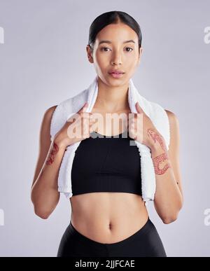 Training like a beast to look good. an attractive young woman standing and posing after her workout. Stock Photo