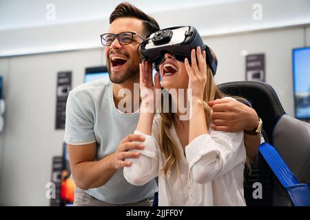 Group of people using virtual reality headset at exhibition, show. VR technology simulation concept Stock Photo
