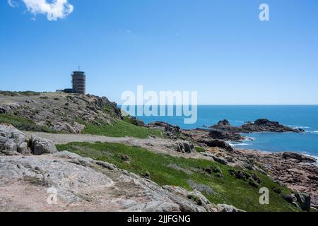 La Corbiere WW2 watchtower on the headland of St Brelade in the south-west of the British Crown Dependency of Jersey, Channel Islands, British Isles. Stock Photo