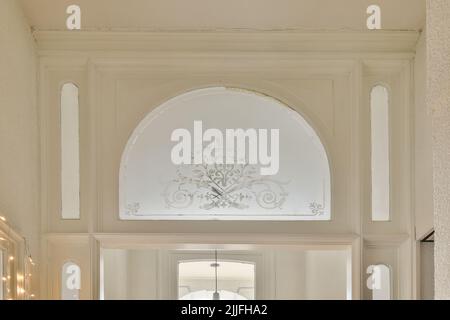 Interior of modern flat in minimal style with narrow empty corridor illuminated by lamps Stock Photo