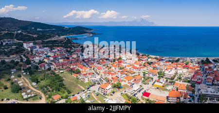 Dark clouds slowly covering Greek town with a shadow. Change in weather. Summer holidays concept. Sarti, Greece. . High quality photo Stock Photo
