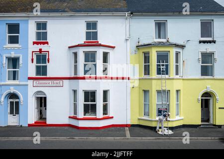 A house painter at work, Borth, Ceredigion, Wales Stock Photo