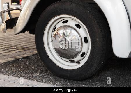 London, UK - November 30, 2021: Vintage Volkswagen Kafer front car wheel with company logotype on chromed cap Stock Photo