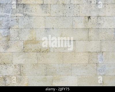 Wall made of white decorative stone. Granite tiles for cladding. Horizontal image. Not seamless texture. Stock Photo