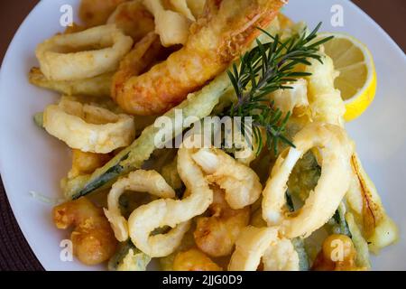 A dish of fresh fish, fried in Italian way. The recipe includes rosemary and lemon. Stock Photo