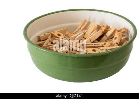 Den Helder, Netherlands. July 2022. An enamel bowl with wooden clothes pegs on a white background. High quality photo. Isolated. Stock Photo