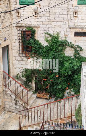 SIBENIK, CROATIA - SEPTEMBER 9, 2016: This is a cozy crossroads of pedestrian alleys-stairs in the old town. Stock Photo