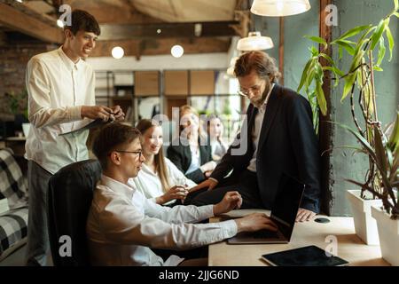 Business people, employees having lively discussion of current professional questions Stock Photo