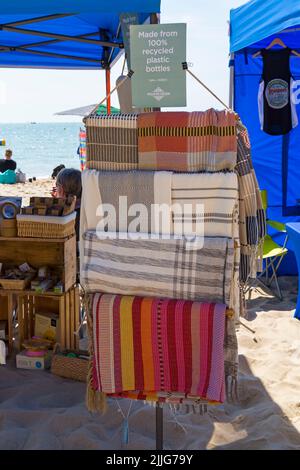 items made from 100% recycled plastic bottles for sale on Dorset ECO stall at event in Poole, Dorset UK in July Stock Photo