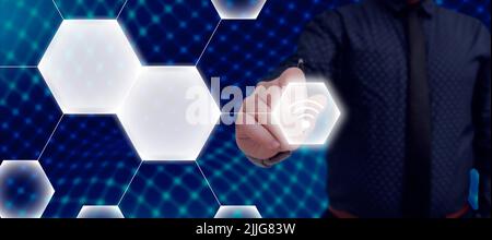 Businessman Holding Pen Which Points On Sign And Presenting Crutial Ideas. Man In Suit Having Pencil In Hand To Show Important Informations. Executive Stock Photo
