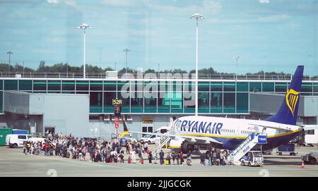 RETRANSMITTING AMENDING DATE Previously unissued photo dated 04/07/22 of passengers queuing to board a Ryanair plane at Stansted Airport, Essex. Issue date: Tuesday July 26, 2022. Stock Photo