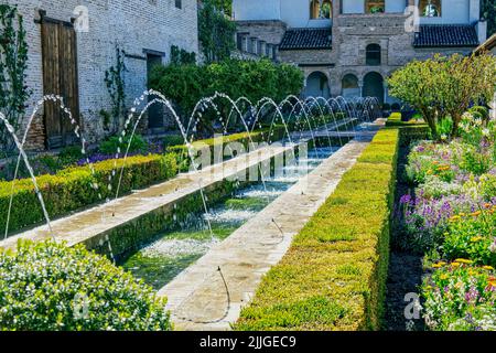 The Patio de la Acequia in the Generalife - Water garden with fountains at the Alhambra palace and fortress in Granada, Andalusia, Spain Stock Photo