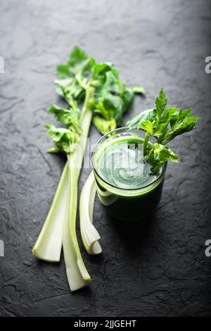 Celery fresh green juice in glass on black background. Healthy vegetarian food concept Stock Photo