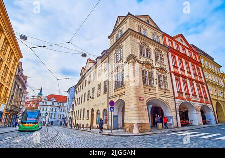 The modern green tram, riding among the medieval townhouses of Malostranske (Lesser Quarter) Square, Prague, Czech Republic Stock Photo