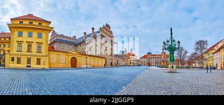 Panorama of historic Castle Square with ornate Schwarzenberg Palace, Canelabra gaslight, Plague Column of Virgin Mary and Tuscany Palace in background Stock Photo