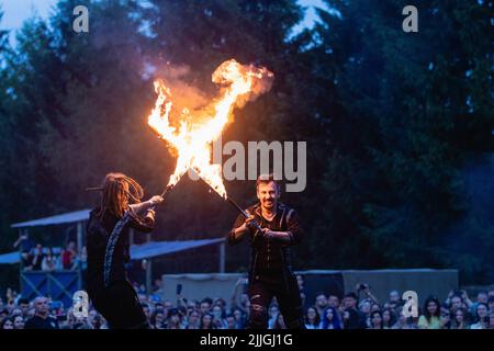 Dudutki, Minsk, Belarus - July 23, 2022 : fire show after International Medieval Festival 'Nash Grunvald', Male performers on stilts Stock Photo