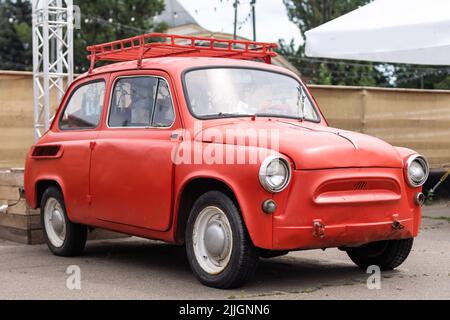 Vintage red tiny car in a parking, 25 August 2022 - Ukraine, Kyiv. Stock Photo