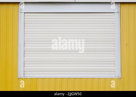 Window with closed roller shutter Stock Photo
