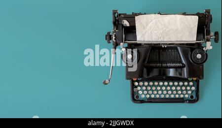 A vintage typewriter on blue background. Stock Photo