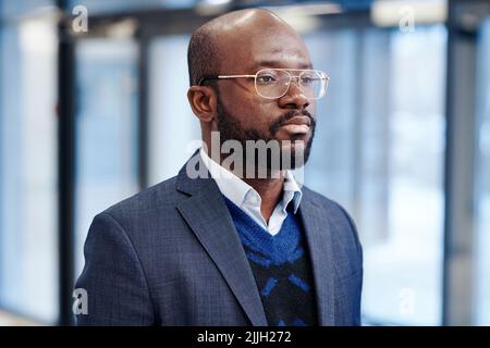 Close-up of African confident businessman in eyeglasses and formal wear looking very presentable standing at office Stock Photo